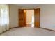 Bedroom view through opened wooden doors with carpet, neutral walls, and glimpses into the hallway and living spaces at 413 Blue Spring Dr, Indianapolis, IN 46239