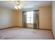 Spacious bedroom features a ceiling fan, carpet flooring, and a window with dark curtains, offering a comfortable retreat at 413 Blue Spring Dr, Indianapolis, IN 46239