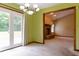 Bright dining room with French doors leading to patio and an open view of the living room with fireplace at 413 Blue Spring Dr, Indianapolis, IN 46239