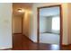 Hallway with wood floors leading to a carpeted bedroom, showcasing the home's layout and transition between spaces at 413 Blue Spring Dr, Indianapolis, IN 46239