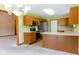 Well-equipped kitchen with wooden cabinets, stainless steel appliances, and a view into the adjacent dining and living areas at 413 Blue Spring Dr, Indianapolis, IN 46239