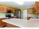 Bright, functional kitchen featuring stainless steel appliances, wood cabinetry, and plenty of counter space at 413 Blue Spring Dr, Indianapolis, IN 46239