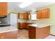 Functional kitchen featuring wood cabinetry and ample counter space, bathed in refreshing natural light at 413 Blue Spring Dr, Indianapolis, IN 46239