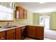 Well-lit kitchen featuring wood cabinets and lots of counter space, with a seamless view into the dining area at 413 Blue Spring Dr, Indianapolis, IN 46239