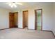 Main bedroom features a ceiling fan, carpet flooring, and two doors: one to a walk-in closet and another to the bathroom at 413 Blue Spring Dr, Indianapolis, IN 46239