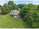 Aerial view of home showcasing lush landscaping, manicured lawn, mature trees, and surrounding neighborhood at 4155 Rolling Trails Rd, Greenwood, IN 46142