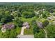 Aerial view of a landscaped property with mature trees and well-manicured lawn in a neighborhood setting at 4155 Rolling Trails Rd, Greenwood, IN 46142