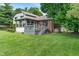 Well-maintained backyard with spacious deck, lush lawn, mature trees, and established landscaping at 4155 Rolling Trails Rd, Greenwood, IN 46142