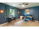 Office bedroom featuring two work stations, built-in shelving, and large windows for natural light at 4155 Rolling Trails Rd, Greenwood, IN 46142