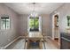 Inviting dining room featuring a modern chandelier, table setting, and view of the backyard at 4155 Rolling Trails Rd, Greenwood, IN 46142