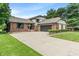 Charming brick home with a well-manicured lawn, attached garage, and ample driveway parking at 4155 Rolling Trails Rd, Greenwood, IN 46142