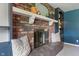 Cozy brick fireplace with a decorative mantel and built-in shelving, creating a warm ambiance at 4155 Rolling Trails Rd, Greenwood, IN 46142