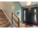 Stylish foyer with wood flooring, a dark front door with sidelights and staircase at 4155 Rolling Trails Rd, Greenwood, IN 46142