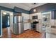 Well-equipped kitchen featuring stainless steel appliances, white cabinets, and hardwood flooring at 4155 Rolling Trails Rd, Greenwood, IN 46142