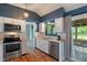Modern kitchen with stainless steel appliances, white cabinetry, and a garden view window at 4155 Rolling Trails Rd, Greenwood, IN 46142