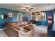 Comfortable living room with blue walls, ceiling fan, and L-shaped sofa at 4155 Rolling Trails Rd, Greenwood, IN 46142