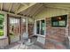 Enclosed porch with brick walls, seating area, and sliding glass door to the home's interior at 4155 Rolling Trails Rd, Greenwood, IN 46142