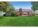 View of the home's backyard with a wooden deck at 430 Oakbrook Dr, Columbus, IN 47201