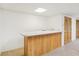 Basement entertainment area featuring wet bar with wood paneling, and tile floors at 430 Oakbrook Dr, Columbus, IN 47201