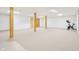 Spacious unfinished basement featuring concrete support beams and neutral-colored carpet at 430 Oakbrook Dr, Columbus, IN 47201