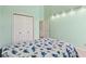 Well lit bedroom with carpeted floor, large closet, pale green walls and dinosaur themed bed at 430 Oakbrook Dr, Columbus, IN 47201