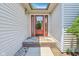 View of charming front entrance with walkway leading to a lovely red door at 430 Oakbrook Dr, Columbus, IN 47201
