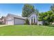Charming single-story home featuring attached garage and well-manicured front lawn at 430 Oakbrook Dr, Columbus, IN 47201