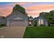 Charming single-story home featuring a two-car garage and manicured lawn at 430 Oakbrook Dr, Columbus, IN 47201