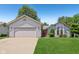 Charming home with a well-maintained front lawn and two-car garage at 430 Oakbrook Dr, Columbus, IN 47201