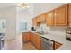 Well-lit kitchen with stainless steel appliances, white countertops, and wood cabinets providing ample storage at 430 Oakbrook Dr, Columbus, IN 47201