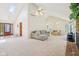 Spacious living room featuring vaulted ceilings, carpeted floors, and abundant natural light at 430 Oakbrook Dr, Columbus, IN 47201