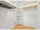 Walk-in closet featuring a modern shelving unit with wood trim and a hanger at 430 Oakbrook Dr, Columbus, IN 47201