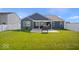 Fenced-in backyard featuring a green lawn and patio with an outdoor hot tub at 4420 Wild Turkey Dr, Indianapolis, IN 46239