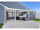 Backyard patio featuring a hot tub, concrete flooring, and an exterior ceiling fan at 4420 Wild Turkey Dr, Indianapolis, IN 46239