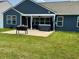 Backyard with well-manicured lawn and covered patio featuring a hot tub at 4420 Wild Turkey Dr, Indianapolis, IN 46239