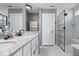 Sleek bathroom featuring a double vanity, glass-enclosed shower, and stylish fixtures at 4420 Wild Turkey Dr, Indianapolis, IN 46239