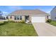 Charming brick home with a well-manicured lawn and attached two car garage at 4420 Wild Turkey Dr, Indianapolis, IN 46239
