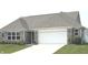 Charming brick home featuring a two-car garage and a well-maintained lawn, offering great curb appeal at 4420 Wild Turkey Dr, Indianapolis, IN 46239