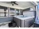Outdoor hot tub with gray siding and black steps under a covered patio at 4420 Wild Turkey Dr, Indianapolis, IN 46239