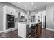 Gourmet kitchen features stainless appliances, double ovens, island with bar seating, and sleek cabinetry at 4420 Wild Turkey Dr, Indianapolis, IN 46239