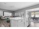Open kitchen with white cabinets and stainless steel appliances leads into the living and dining areas at 4420 Wild Turkey Dr, Indianapolis, IN 46239