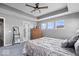 Calm main bedroom featuring tray ceilings, neutral colors, and large windows at 4420 Wild Turkey Dr, Indianapolis, IN 46239
