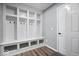 Organized mudroom with built-in cubbies, bench seating, and a sleek vinyl floor at 4420 Wild Turkey Dr, Indianapolis, IN 46239