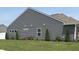Well-manicured side yard with lush lawn, clean siding, and updated trim at 4420 Wild Turkey Dr, Indianapolis, IN 46239