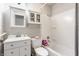 Clean bathroom featuring a built-in medicine cabinet, a shower-tub combo, and white fixtures at 48 Wilson Dr, Carmel, IN 46032