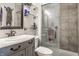 Charming bathroom boasts a vanity with marble countertop, glass shelves, and a shower with glass door at 48 Wilson Dr, Carmel, IN 46032