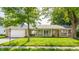 Charming ranch-style home featuring an attached garage, a front porch, and mature landscaping at 48 Wilson Dr, Carmel, IN 46032