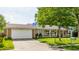 Inviting one-story home with a garage, large front yard, and a covered porch with white railings at 48 Wilson Dr, Carmel, IN 46032