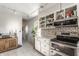 Well-lit kitchen featuring open shelving, stainless steel appliances, and a view of adjoining rooms at 48 Wilson Dr, Carmel, IN 46032