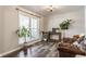 Inviting living room with hardwood floors, a decorative console table, and a comfortable leather sofa at 48 Wilson Dr, Carmel, IN 46032